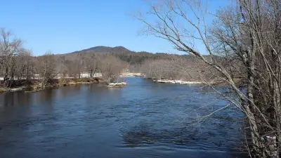 Androscoggin River at Bethel, Maine, with snow along its banks in late March.