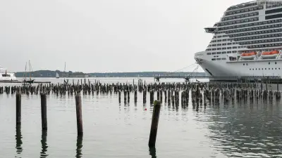 Portland Harbor with historic wooden pilings and a docked cruise ship, Maine.