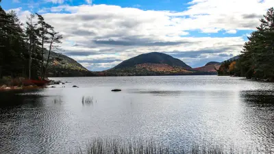 Eagle Lake framed by forest and low mountains in Acadia National Park, Maine