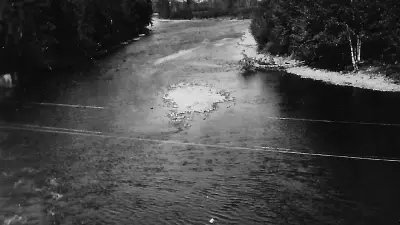 Historic black-and-white photograph of the Fish River at Fort Kent in September 1940, showing wooded banks and exposed river stones.