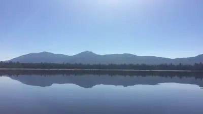 The Bigelow Mountains reflected in still water on Flagstaff Lake.