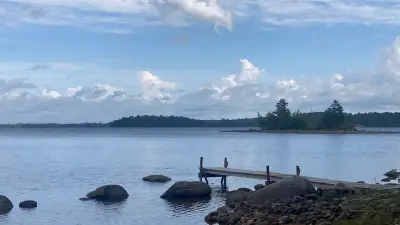 A small dock and rocky shoreline overlooking Gardner Lake in East Machias.