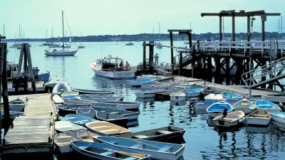 Rowboats and sailboats around the docks at Kittery Point harbor in an archival photograph taken between 1980 and 2006.