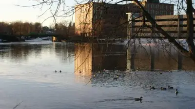 Presumpscot River in winter at Westbrook, looking toward Bridge Street and Saccarappa Falls.